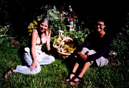 Garden artist Susanna Bahaar and Jean with baskets of harvest.